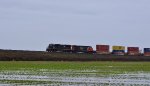 E/B unit stack train climbing the grade to the Hwy 99 overpass with IC 1011 leading CN 2897